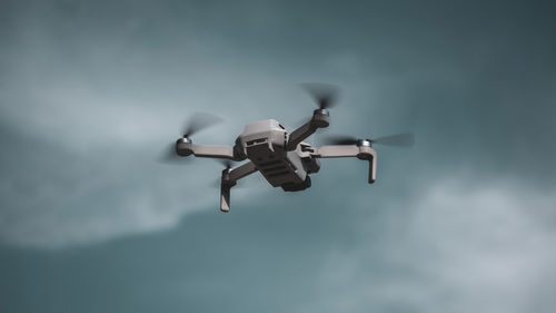 Low angle view of airplane flying against sky