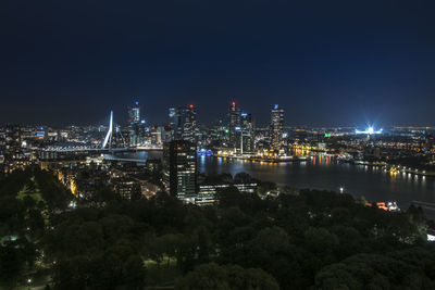 Illuminated cityscape against sky at night