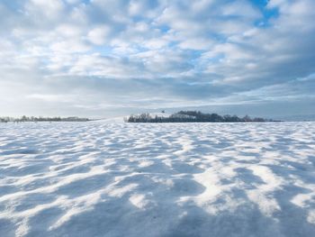 Snow on land against sky