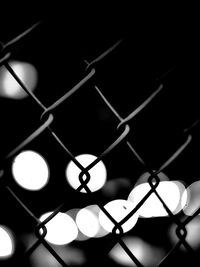 Close-up of illuminated chainlink fence