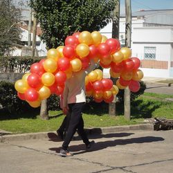 Full length of woman with balloons at park in city