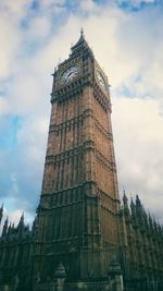 Low angle view of clock tower against cloudy sky