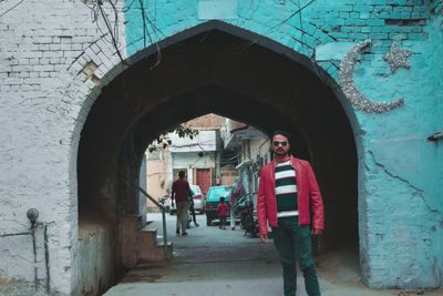 Portrait of man standing at historic building