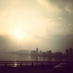 Bridge over river with cityscape in background