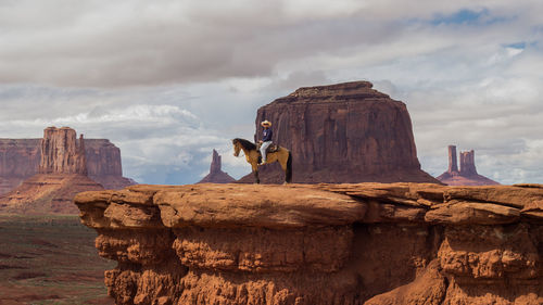 View of rock formations against cloudy sky