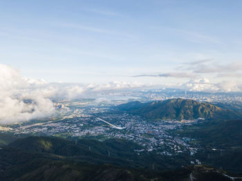 Aerial view of landscape against cloudy sky