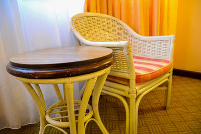 Close-up of chair by table at home