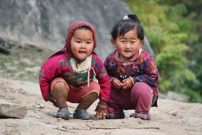 Portrait of a smiling girl sitting outdoors