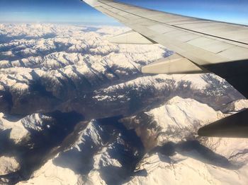 Aerial view of airplane wing over landscape