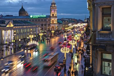 High angle view of illuminated city street amidst buildings