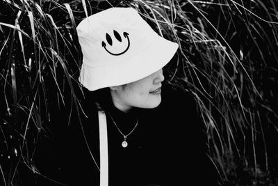 Portrait of woman with hat against plants