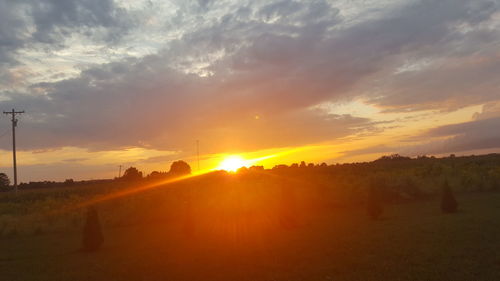 Scenic view of field against sky during sunset