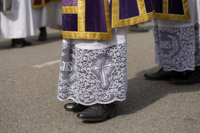 Low section of priests standing on road