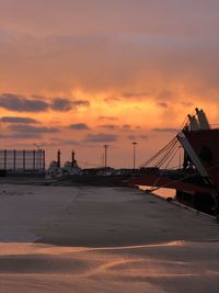 Bridge over sea against sky during sunset