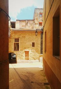 Empty alley amidst buildings in city