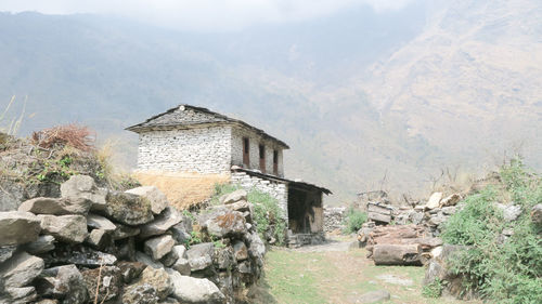 Old building by rocky mountain