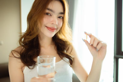 Portrait of beautiful woman drinking glass
