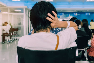 Rear view of people sitting on chair