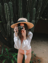 Midsection of woman wearing hat