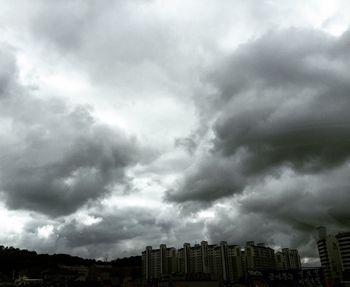 Buildings against cloudy sky