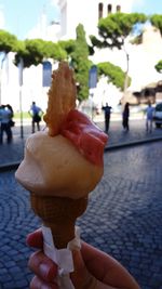 Close-up of hand holding ice cream cone