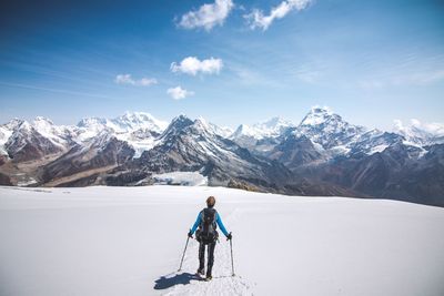 Tourists on snow covered mountain