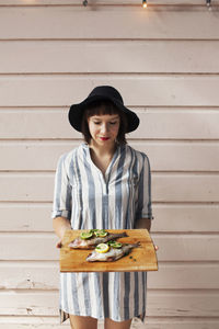 Woman holding fish on cutting board