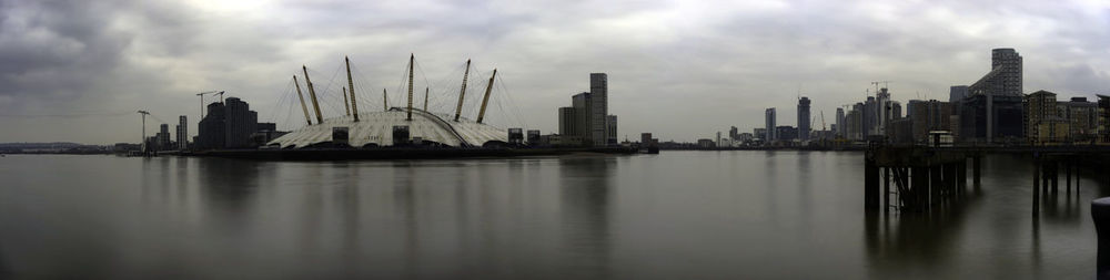 Panoramic view of river by buildings against sky