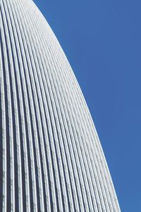 Low angle view of modern building against clear blue sky