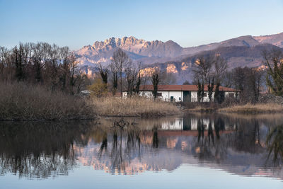 Scenic view of lake and mountains against clear sky