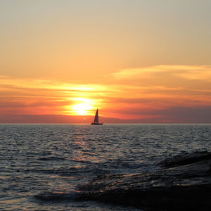 Scenic view of sea against orange sky