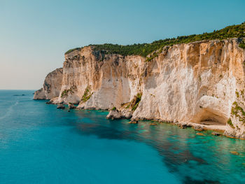 Aerial dramatic white cliffs on paxos island in greece in the summertime.