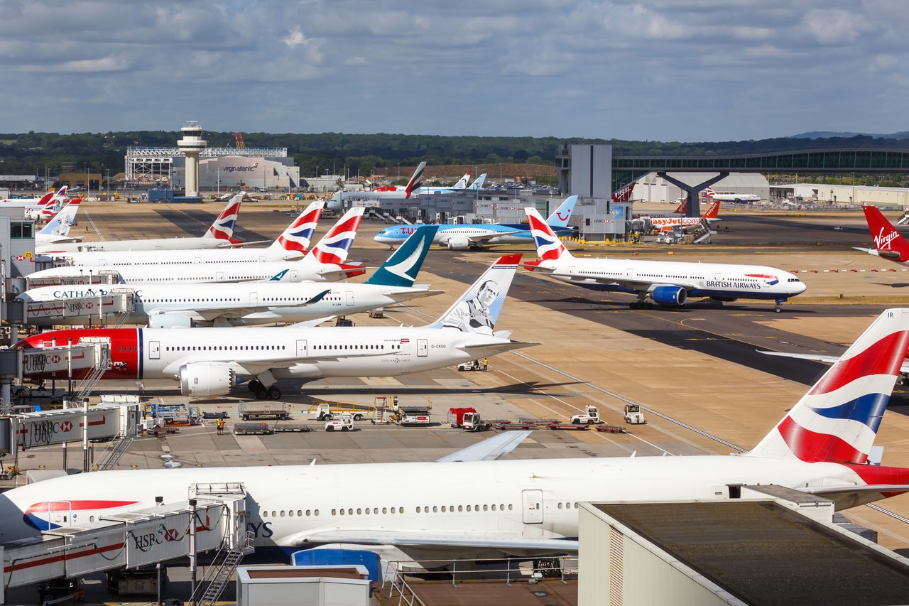 HIGH ANGLE VIEW OF AIRPLANE ON AIRPORT RUNWAY