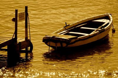 Boat moored in lake against sky