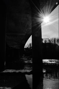 Sun shining through bridge