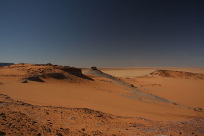 Scenic view of desert against clear sky