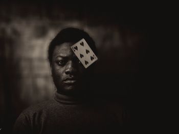 Portrait of man with playing card