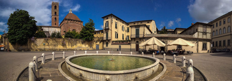 Buildings against cloudy sky