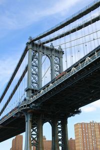 Low angle view of manhattan bridge against sky