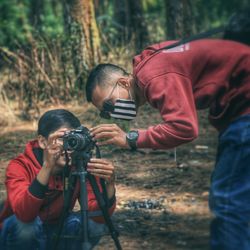 People photographing in forest