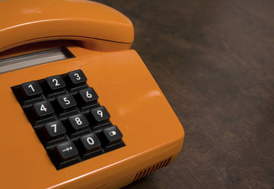 Close-up of telephone on table