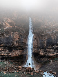 Standing in front of the waterfall 