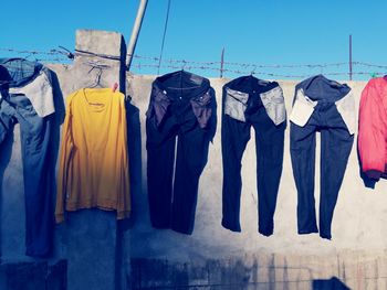 Clothes drying on clothesline against blue sky