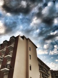 Low angle view of building against cloudy sky