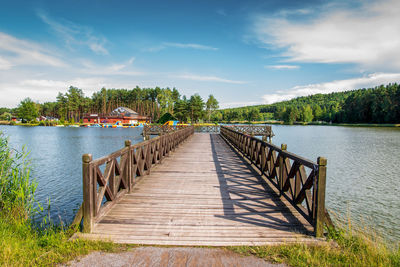 A beautiful wooden pier over the lagoon. the golden hour . krasnobród, poland