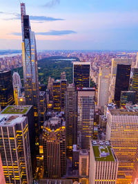 Aerial view of buildings in city against sky