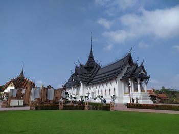 Temple by building against sky