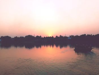 Scenic view of lake against orange sky