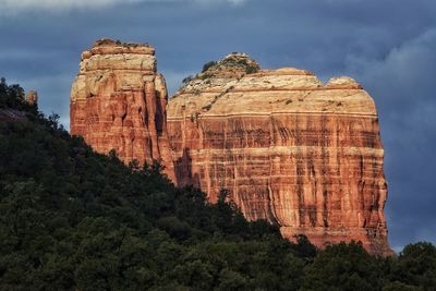 Rock formation against cloudy sky at village of oak creek