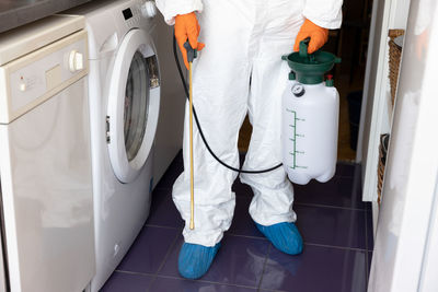 Low section of man standing in bathroom